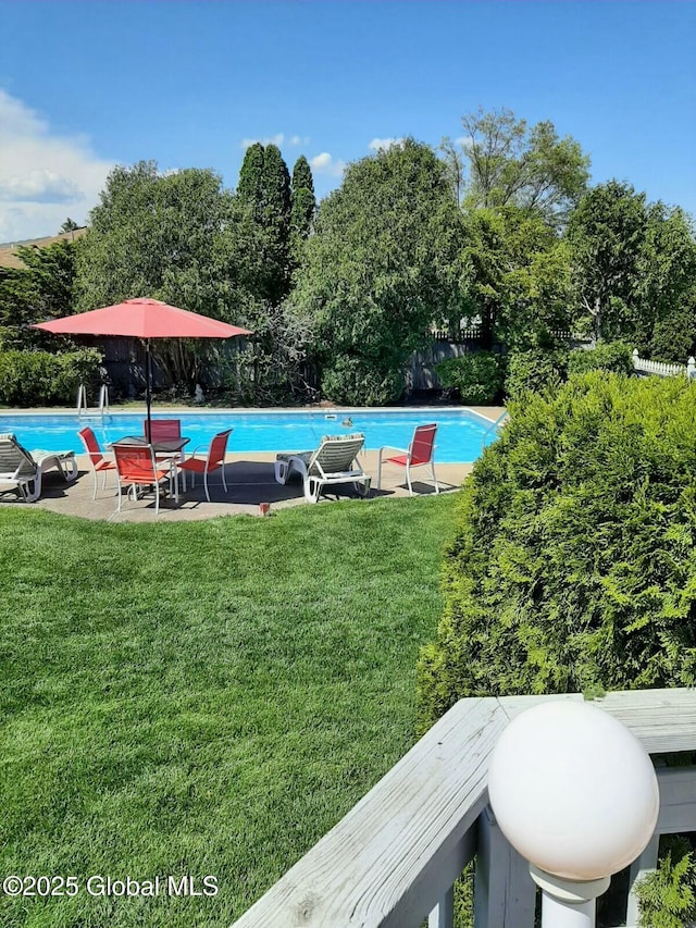 view of pool with a lawn