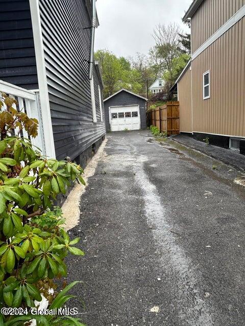 view of property exterior featuring a garage and an outdoor structure