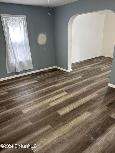 spare room with dark hardwood / wood-style floors