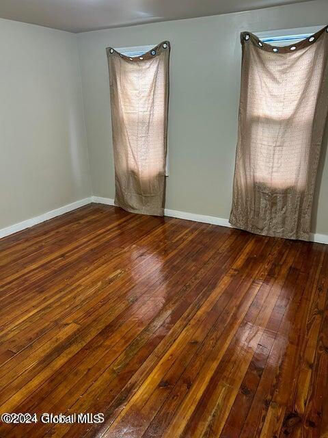 empty room with dark wood-type flooring