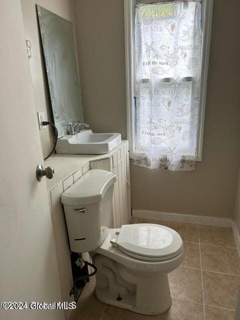 bathroom featuring tile patterned flooring, toilet, and sink