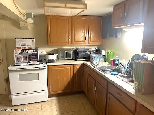 kitchen featuring sink and light tile patterned flooring