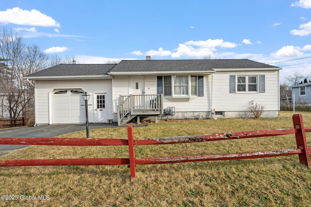 single story home featuring a garage and a front lawn