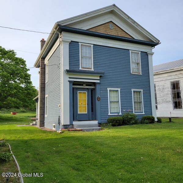 neoclassical home with a front yard