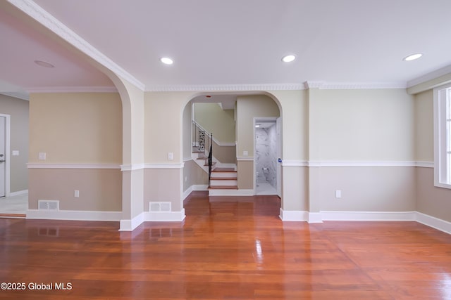 801 Holland Rd, Schenectady, NY 12303 - empty room featuring wood finished floors, stairway, arched walkways, recessed lighting, and crown molding