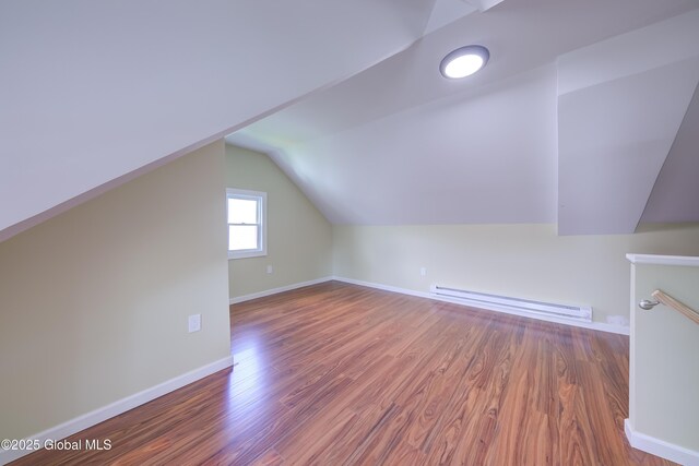 801 Holland Rd, Schenectady, NY 12303 - bonus room featuring a baseboard heating unit, vaulted ceiling, and wood finished floors