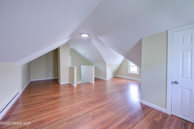 801 Holland Rd, Schenectady, NY 12303 - bonus room with baseboard heating, light wood-style flooring, and lofted ceiling
