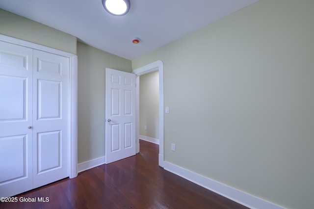 801 Holland Rd, Schenectady, NY 12303 - unfurnished bedroom featuring dark wood-style floors and a closet
