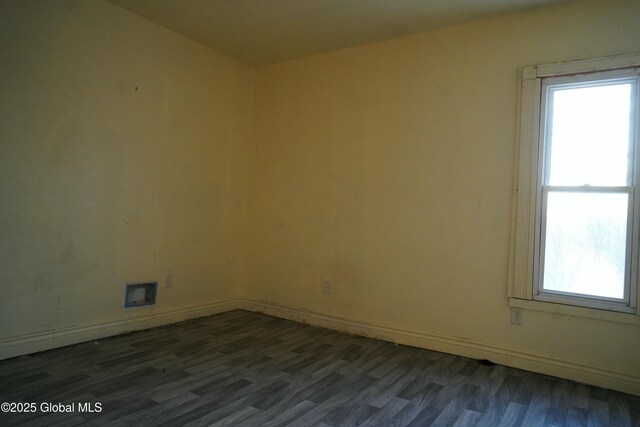 spare room featuring dark hardwood / wood-style flooring