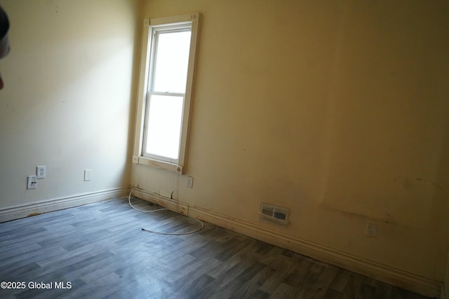 unfurnished room featuring hardwood / wood-style flooring