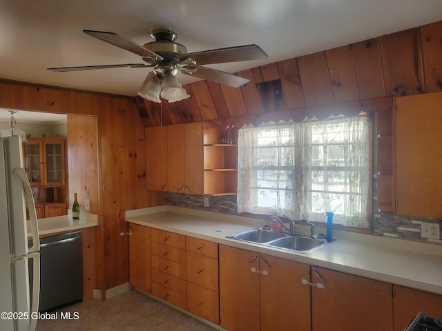 kitchen with vaulted ceiling, ceiling fan, sink, white refrigerator, and dishwasher