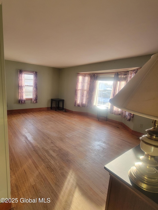 unfurnished living room featuring plenty of natural light and light wood-type flooring