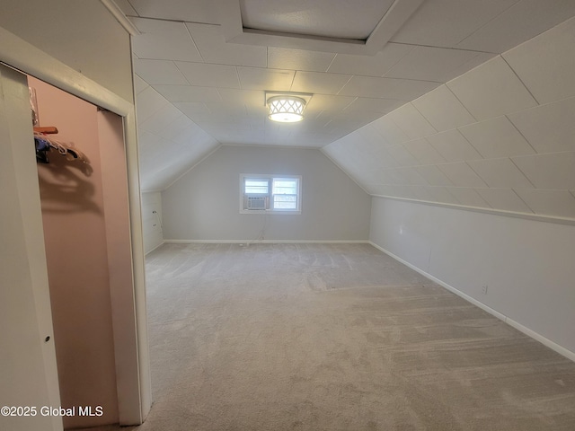 bonus room featuring light colored carpet, vaulted ceiling, and baseboards