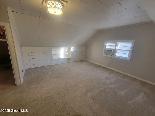 additional living space with carpet floors, vaulted ceiling, and baseboards