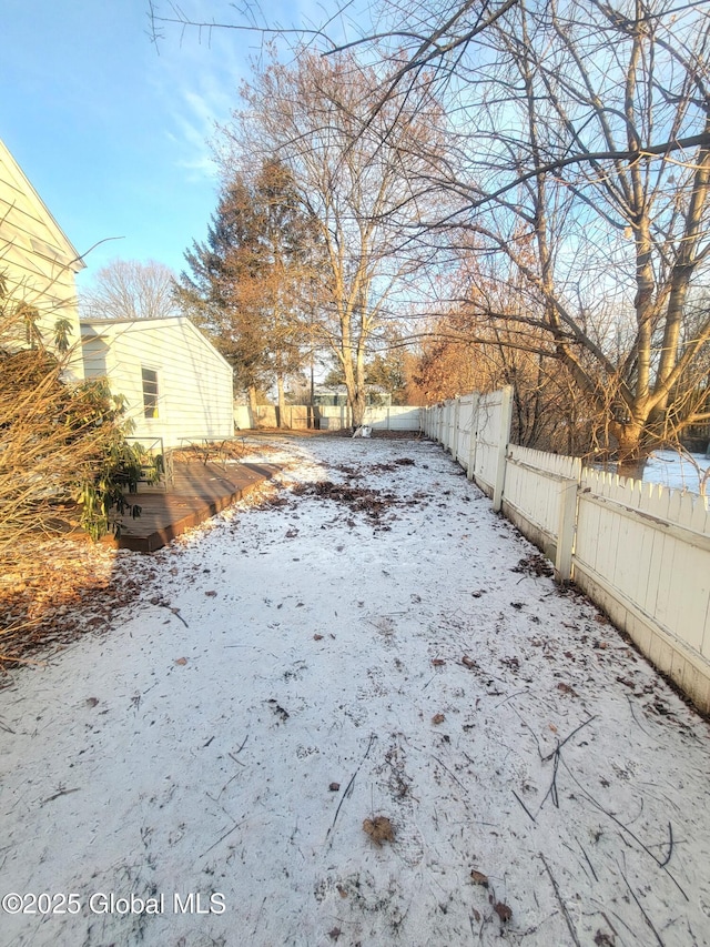 snowy yard featuring a wooden deck