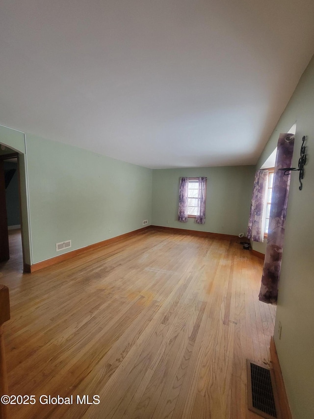 interior space with light wood finished floors, baseboards, and visible vents