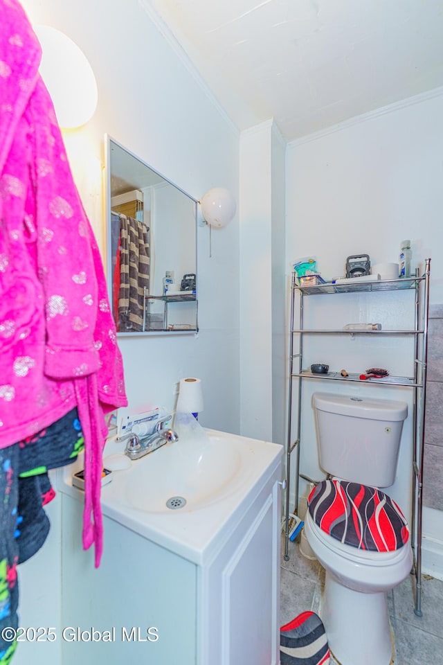 bathroom featuring vanity, toilet, and ornamental molding