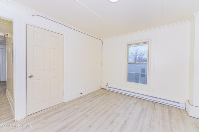 unfurnished room featuring crown molding, light hardwood / wood-style flooring, and a baseboard radiator