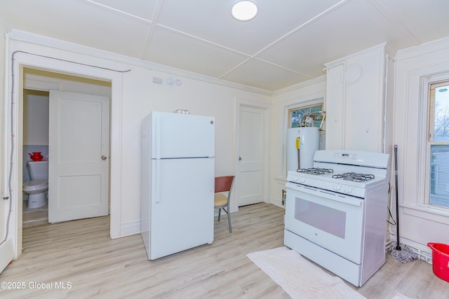 kitchen with white cabinets, light wood-type flooring, white appliances, and water heater