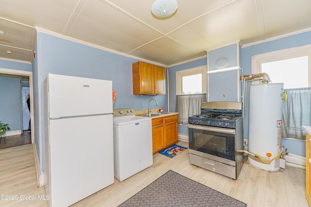 kitchen featuring white refrigerator, sink, water heater, gas stove, and washer / clothes dryer