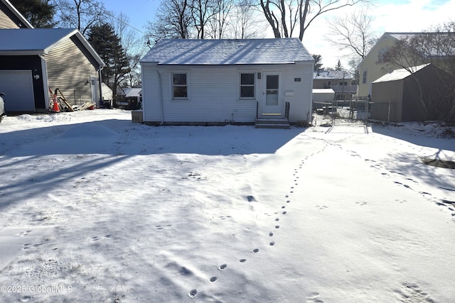 view of snow covered back of property