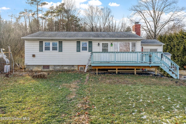 view of front of property with a front yard and a deck