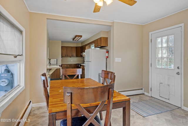 dining space with ceiling fan, a baseboard radiator, and ornamental molding