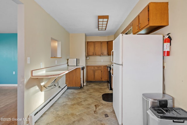 kitchen featuring white appliances and a baseboard heating unit