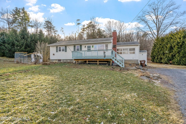 view of front of home with a deck and a front yard