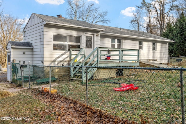 rear view of house featuring a yard and a deck