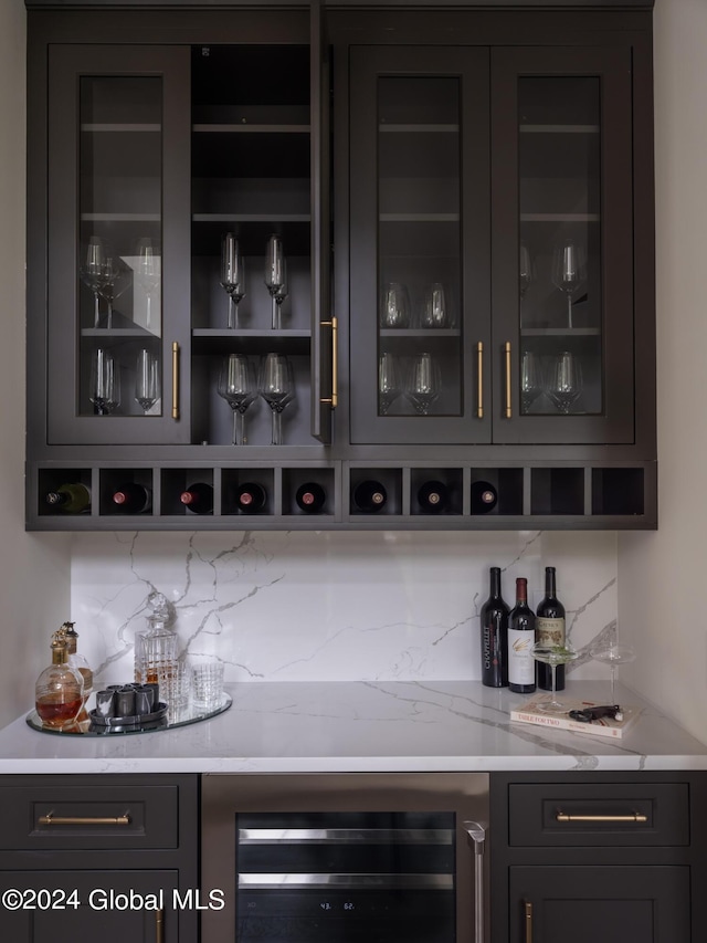 bar with wine cooler and tasteful backsplash