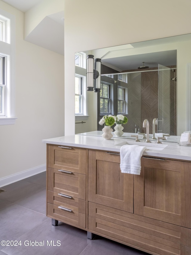 bathroom with vanity, tile patterned floors, and a shower with shower door