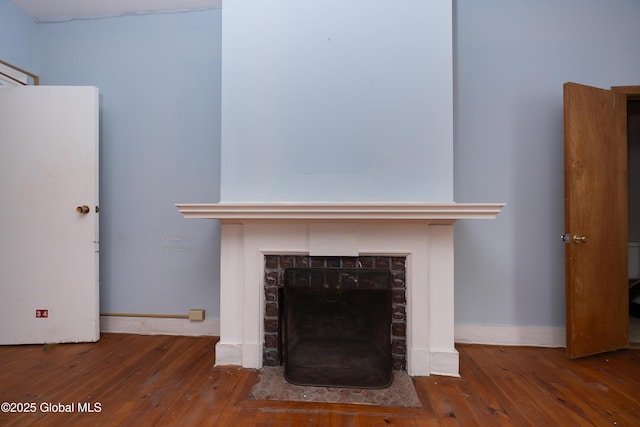 details with wood-type flooring and a brick fireplace