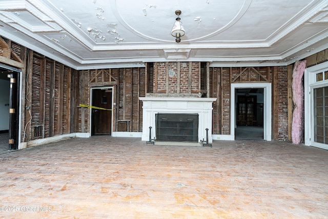 unfurnished living room with a tray ceiling and crown molding