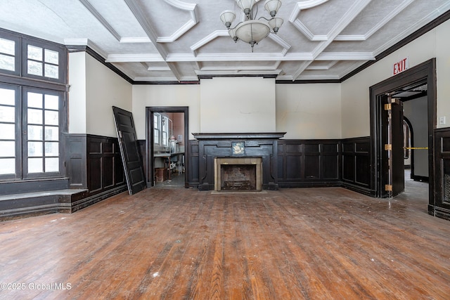 unfurnished living room featuring beam ceiling, hardwood / wood-style flooring, coffered ceiling, and ornamental molding