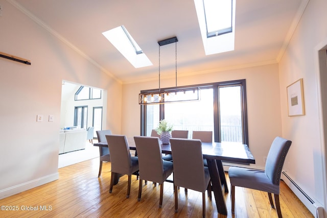 dining room with ornamental molding, lofted ceiling with skylight, baseboard heating, a chandelier, and light hardwood / wood-style floors