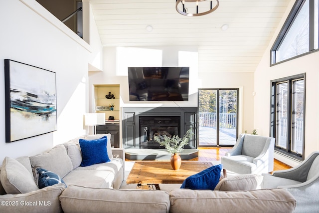 living room with hardwood / wood-style floors, wood ceiling, and high vaulted ceiling