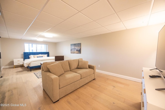 bedroom featuring a paneled ceiling and light hardwood / wood-style floors