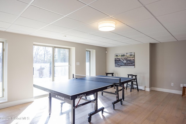 rec room featuring hardwood / wood-style floors, a paneled ceiling, and a baseboard radiator