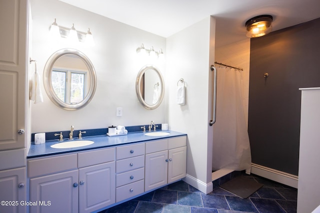 bathroom with curtained shower, vanity, and a baseboard heating unit