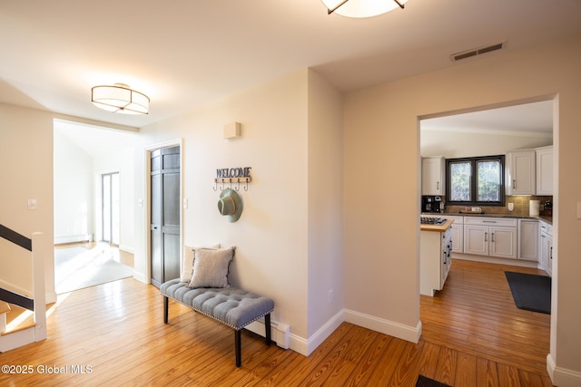 hallway featuring light wood-type flooring and baseboard heating