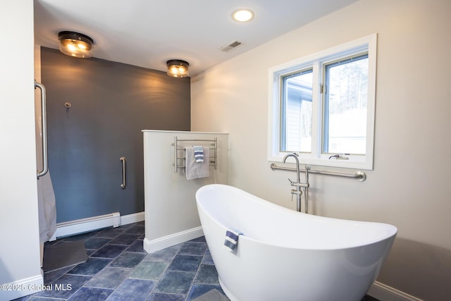 bathroom with a bath and a baseboard heating unit