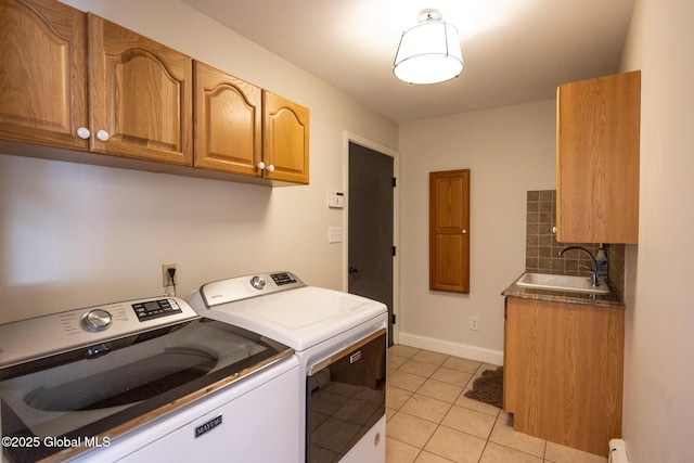 washroom featuring sink, cabinets, baseboard heating, independent washer and dryer, and light tile patterned floors