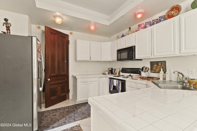 kitchen featuring stainless steel fridge, sink, white electric stove, white cabinets, and light tile patterned flooring