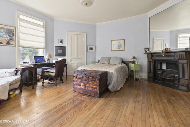 bedroom with light hardwood / wood-style floors and ornamental molding