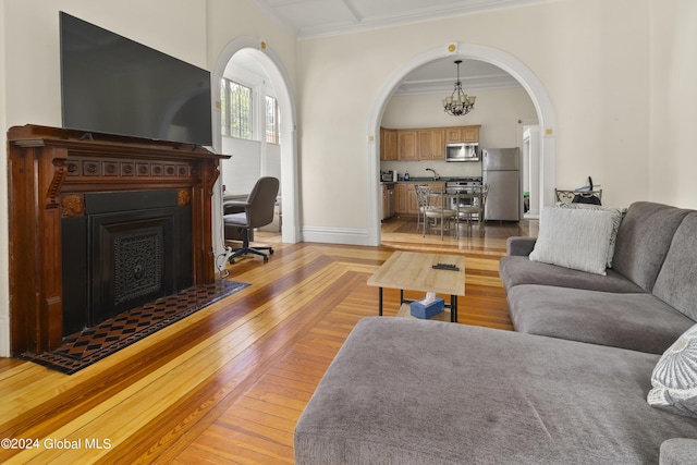 living room with a chandelier and crown molding