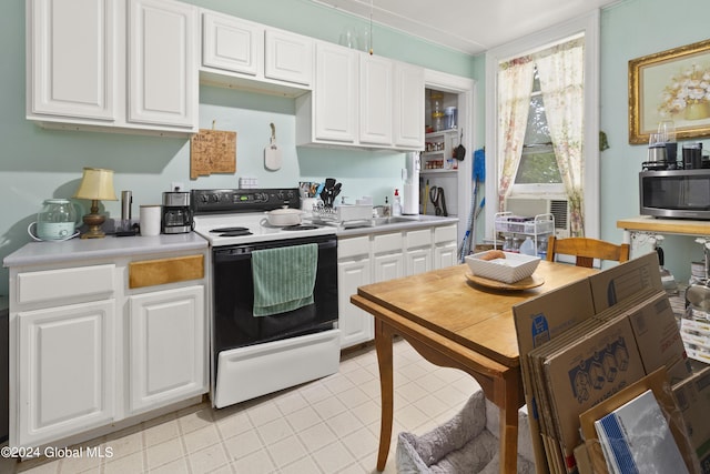 kitchen featuring white cabinets and white electric range