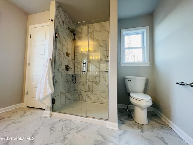 bathroom with toilet and a shower with door