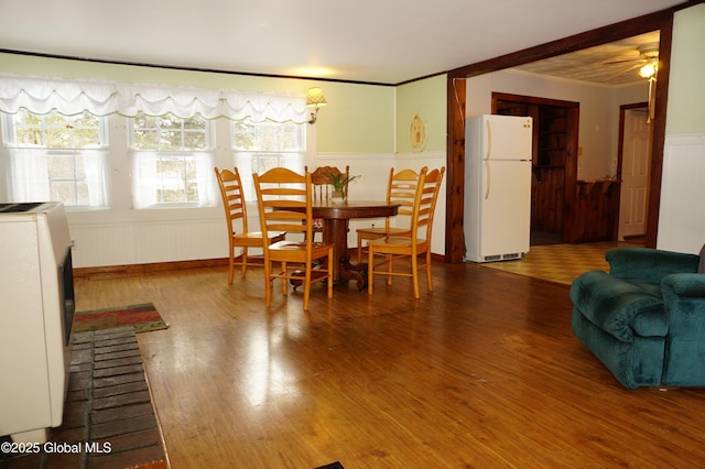 dining area with hardwood / wood-style flooring and ornamental molding