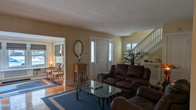 living area featuring stairs and wood finished floors